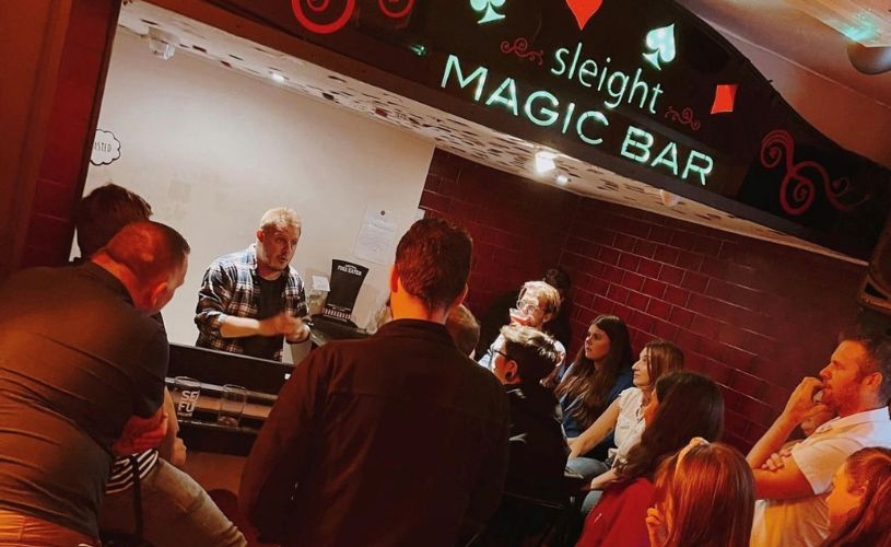 Crowd watching barman at Sleight Magic Bar in Bath